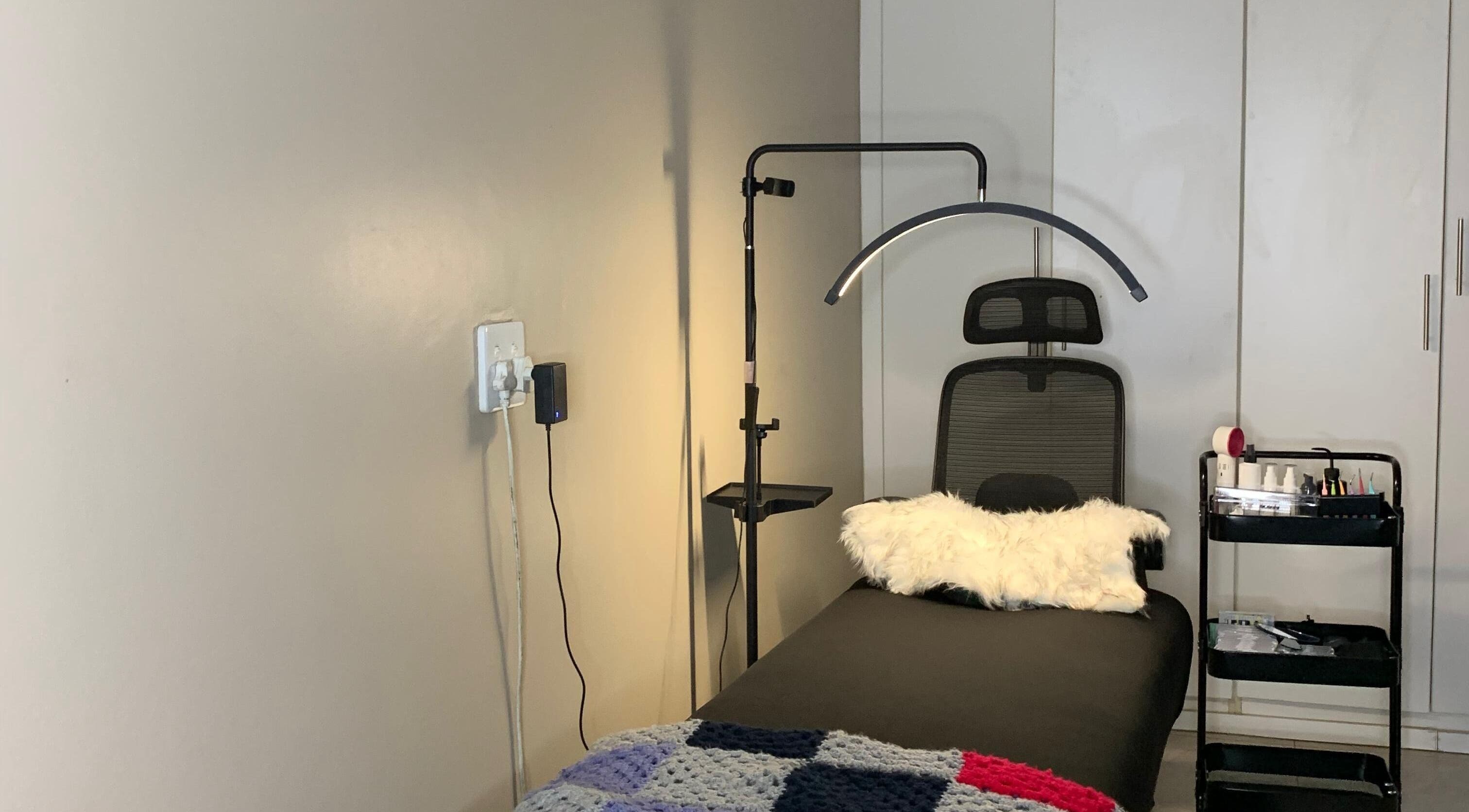 Relaxing treatment room at Vinyl Vici in Pretoria, Gauteng, ZA featuring a comfortable chair and modern decor.