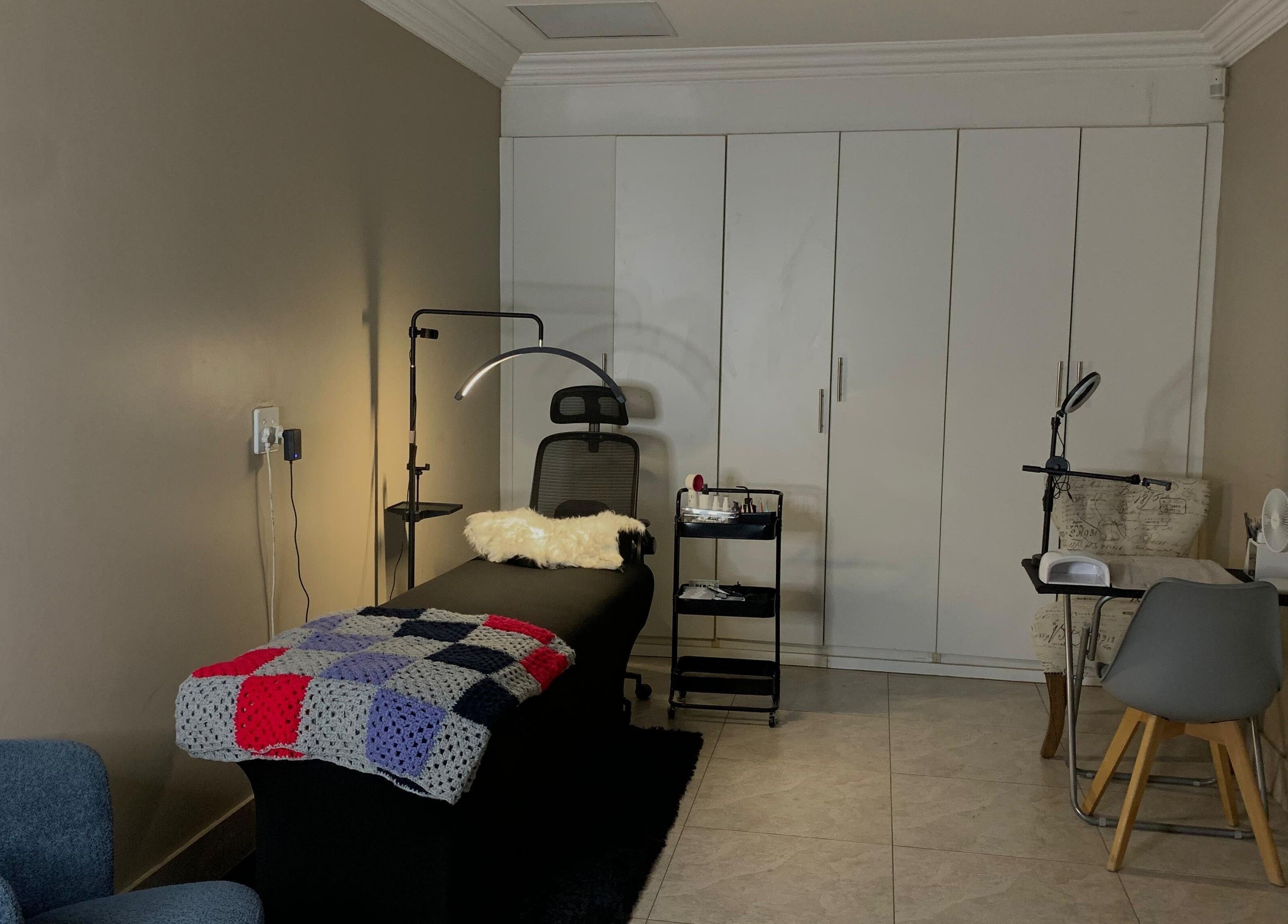 Comfortable treatment room at Vinyl vici, Pretoria, Gauteng, ZA, featuring a massage bed and modern decor.