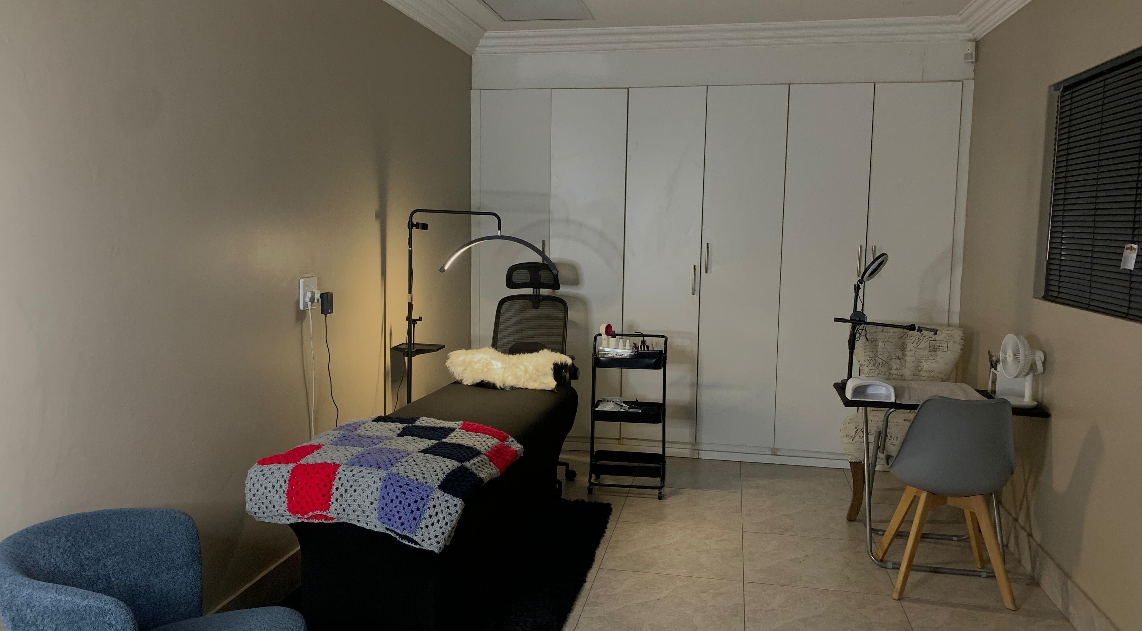 Comfortable treatment room at Vinyl vici, Pretoria, Gauteng, ZA, featuring a massage bed and modern decor.