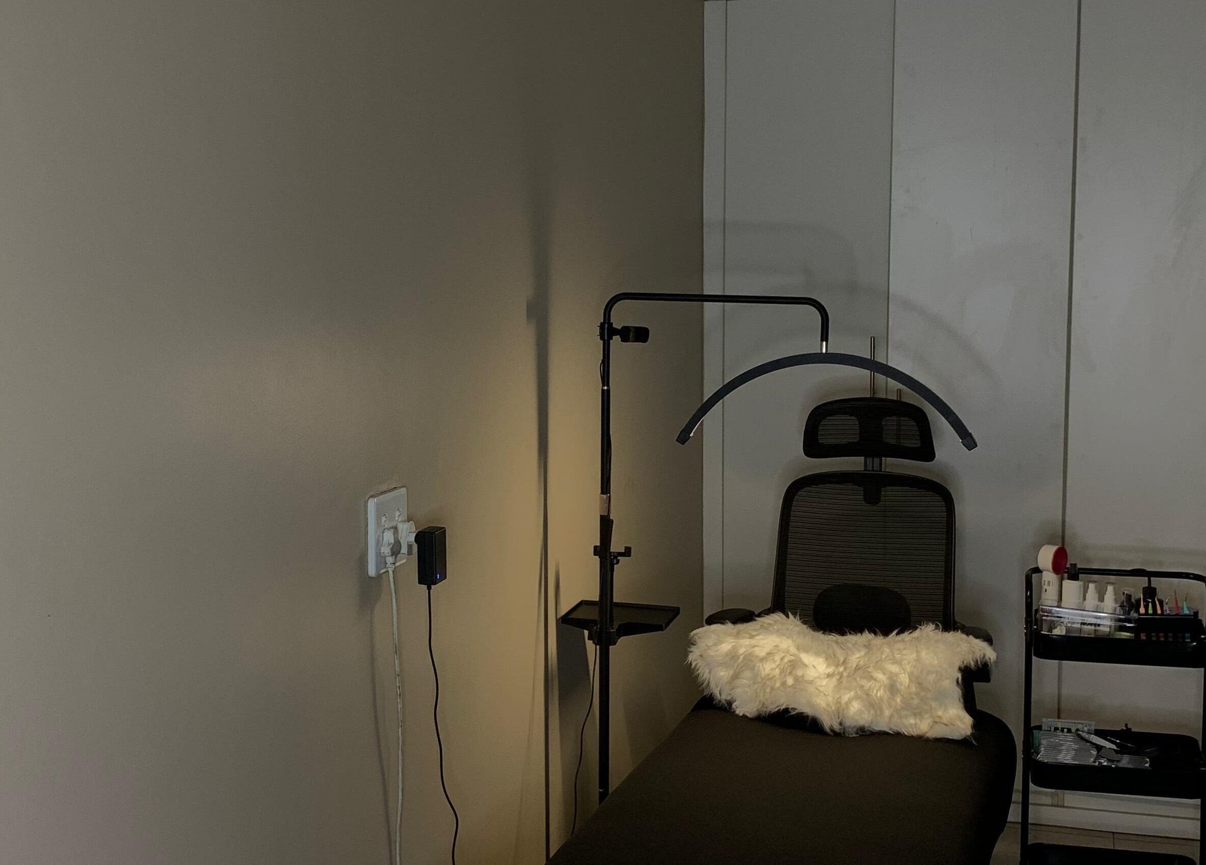 Cozy beauty treatment room at Vinyl Vici, Pretoria, Gauteng, ZA, featuring a plush chair and professional setup.