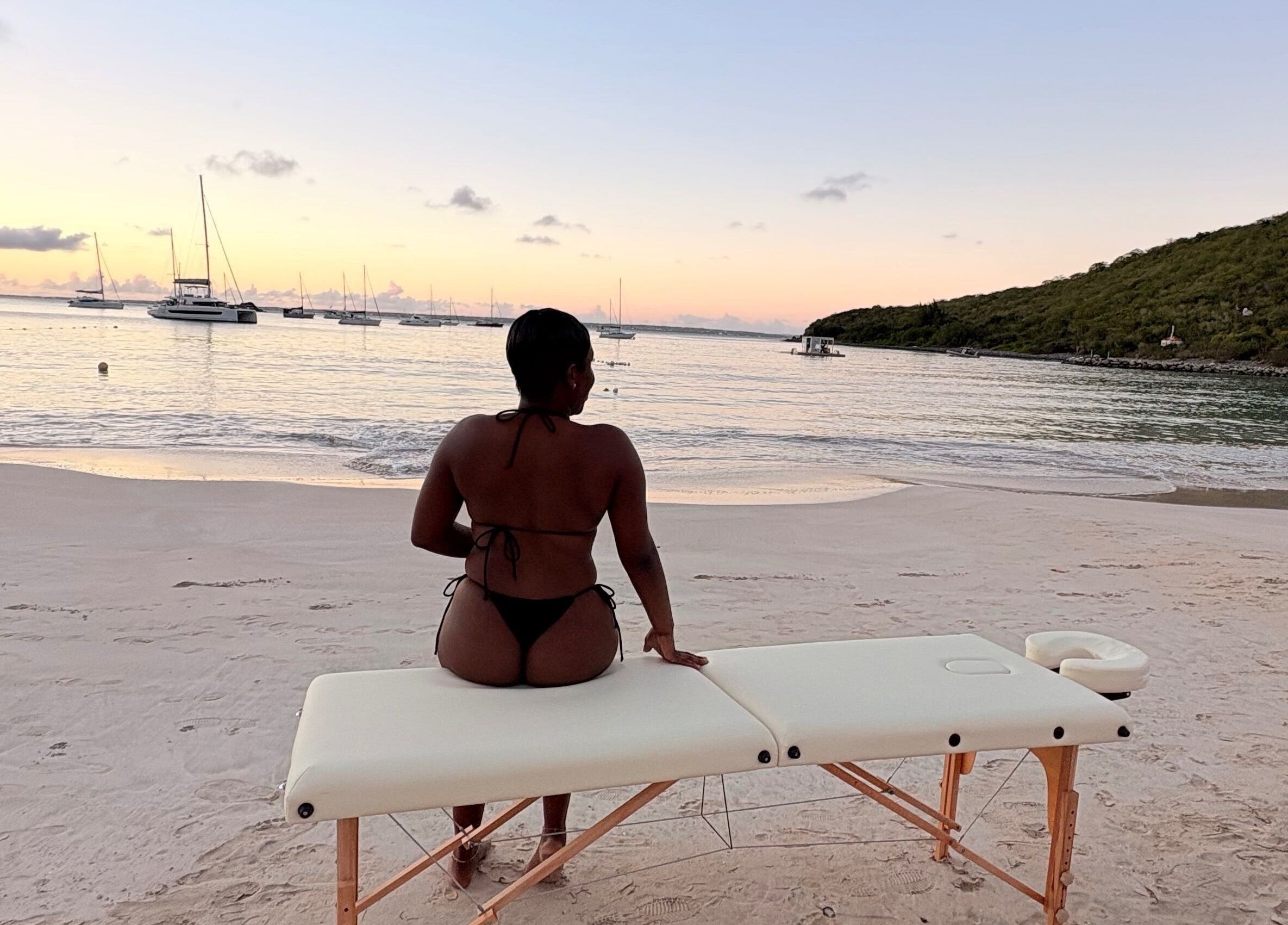Relaxing beach massage setup at Theglamfactorysx/Thehealing haven, Marigot, MF at sunset.