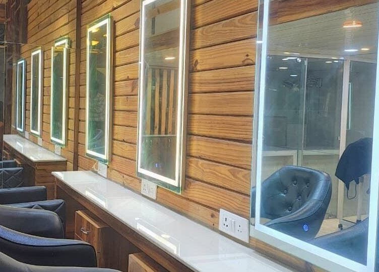 Sleek salon interiors at LumeSpot unisex salon in Greater Noida, Uttar Pradesh, IN with illuminated mirrors.