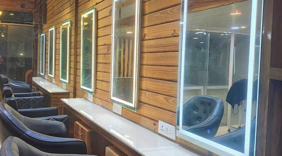 Sleek salon interiors at LumeSpot unisex salon in Greater Noida, Uttar Pradesh, IN with illuminated mirrors.