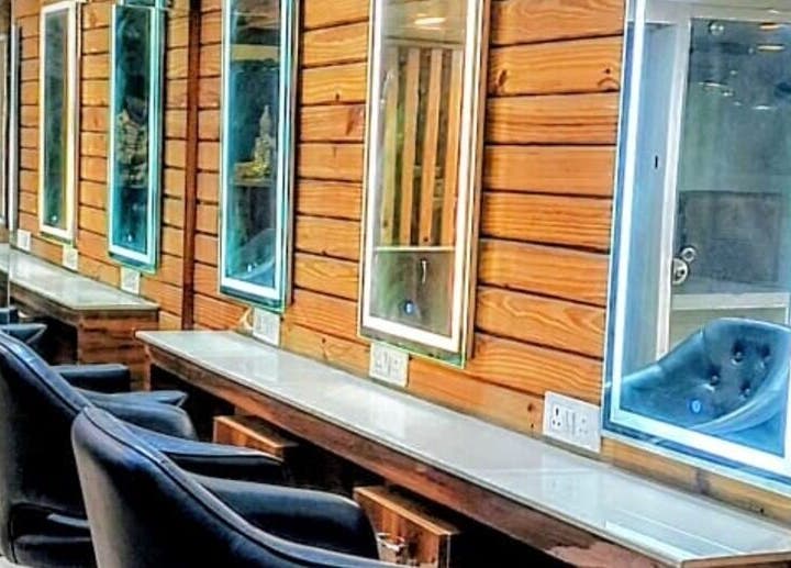 Elegant mirrors and chairs enhance the LumeSpot unisex salon in Greater Noida, Uttar Pradesh, IN.