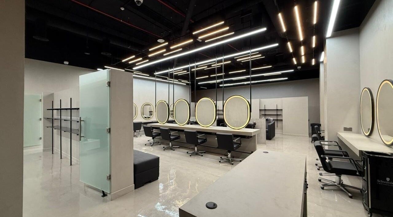 Modern salon interior at Tony El Mendelek, Riyadh, Riyadh Province, SA featuring sleek design and illuminated mirrors.