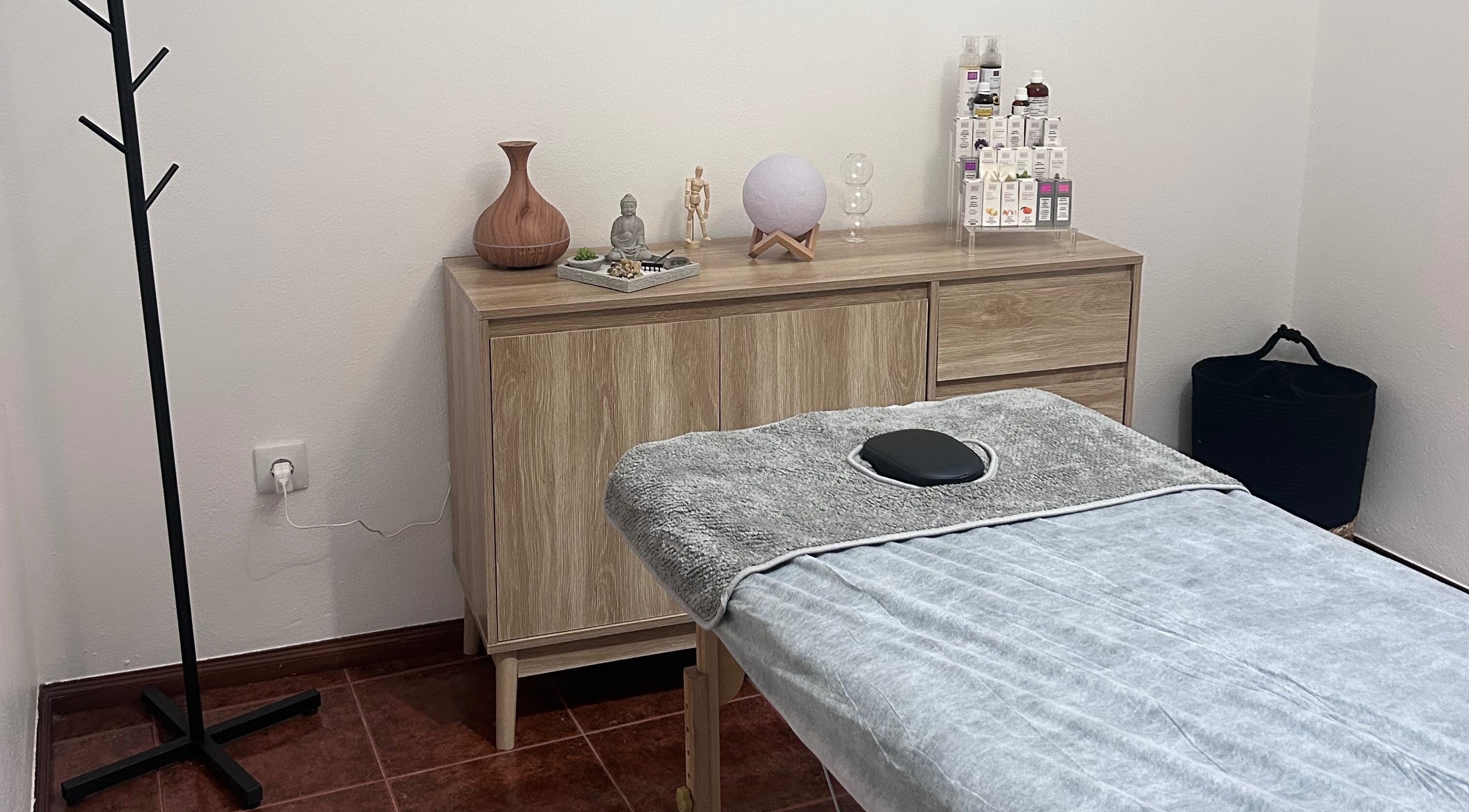 Sala de massagem tranquila no MassagembyPC, Leiria, PT, com mesa e decoração relaxante.