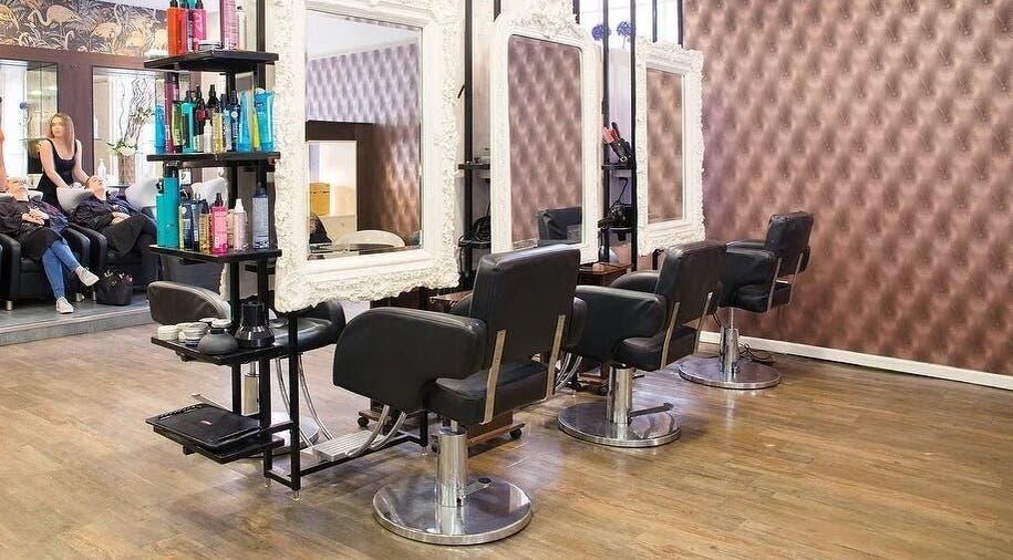 Stylish interior of Renegade hair studio, Leeds, England, GB with elegant salon chairs and ornate mirrors.