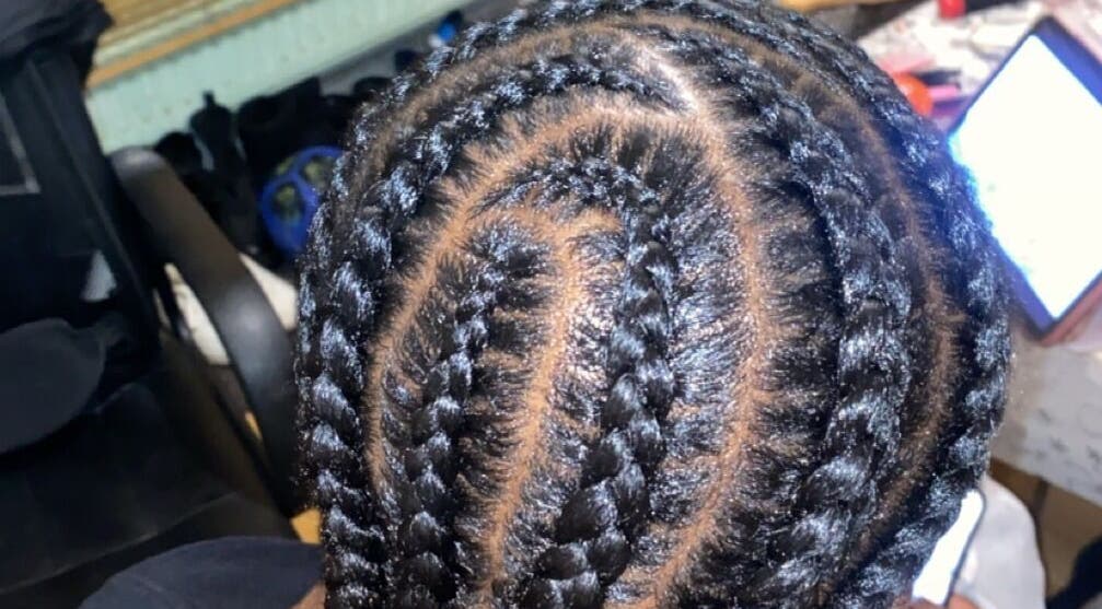 Intricate cornrow braids at Hairbyjamss, Leicester, England, GB, showcasing expert styling.