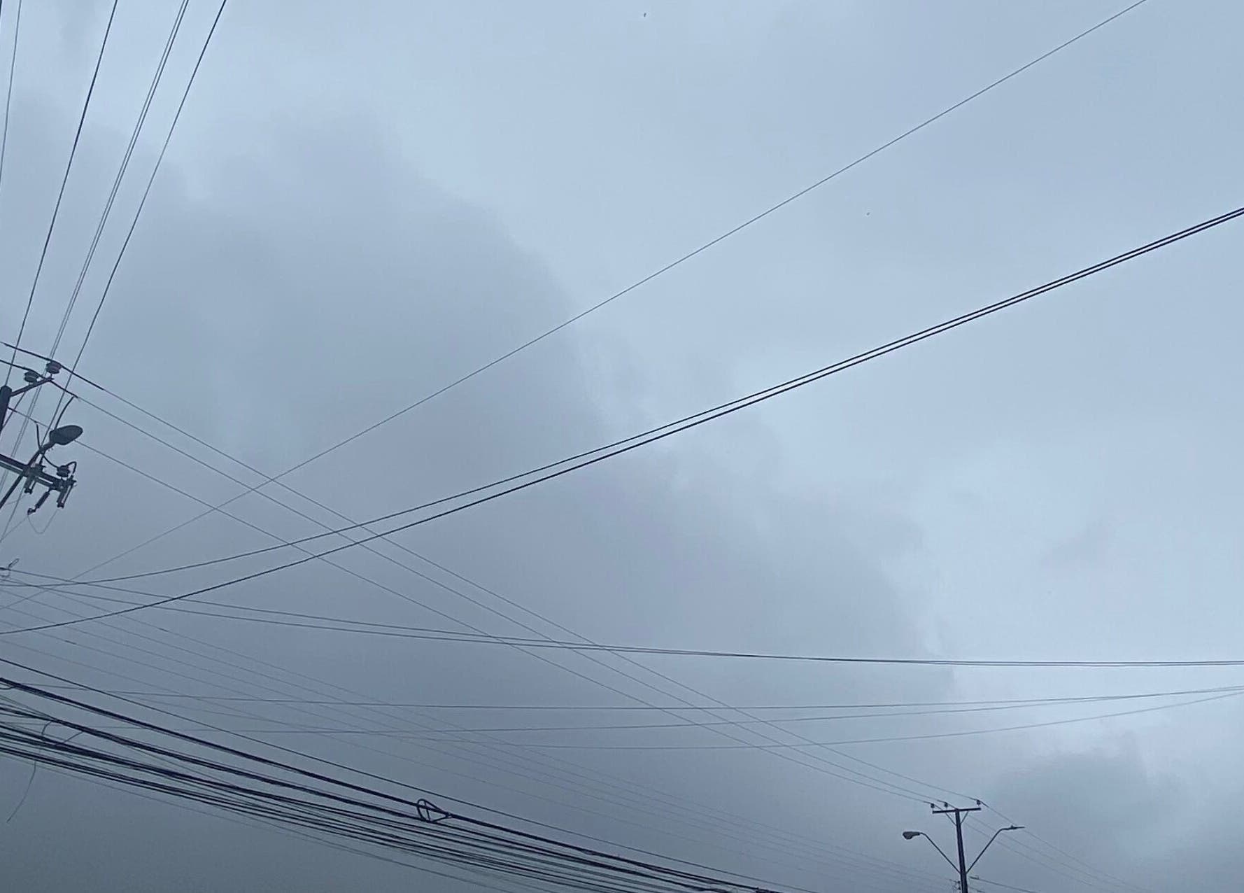 Overcast sky with power lines near Belen.nails.pm, Puerto Montt, Los Lagos, CL.