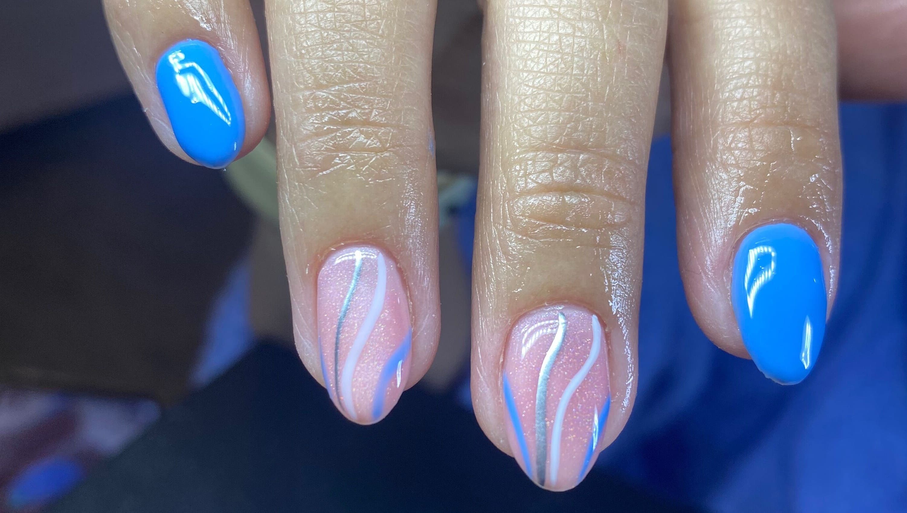 Vibrant blue and wave-patterned nails at Caminnails, Mar Del Plata, Provincia De Buenos Aires, AR.