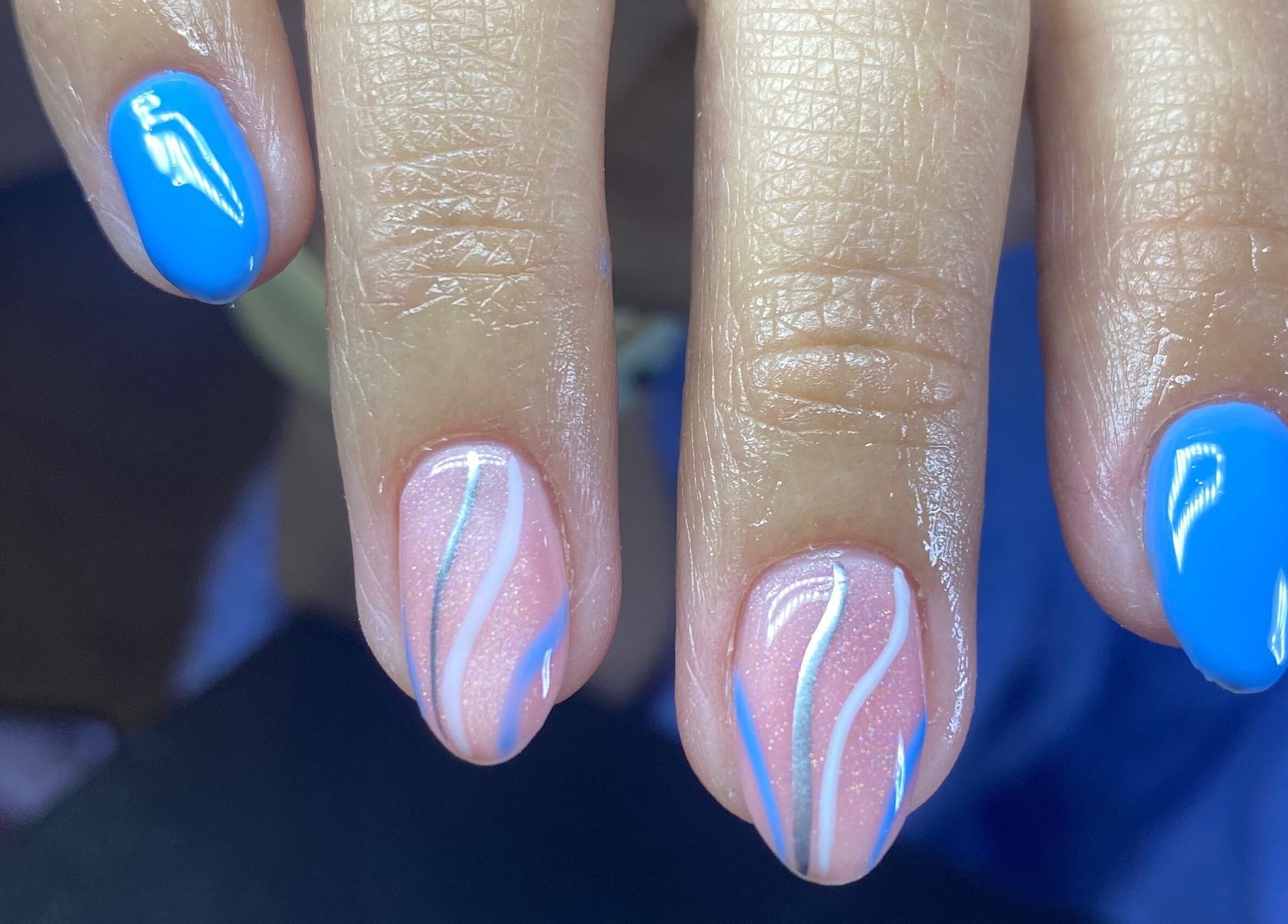 Vibrant blue and wave-patterned nails at Caminnails, Mar Del Plata, Provincia De Buenos Aires, AR.