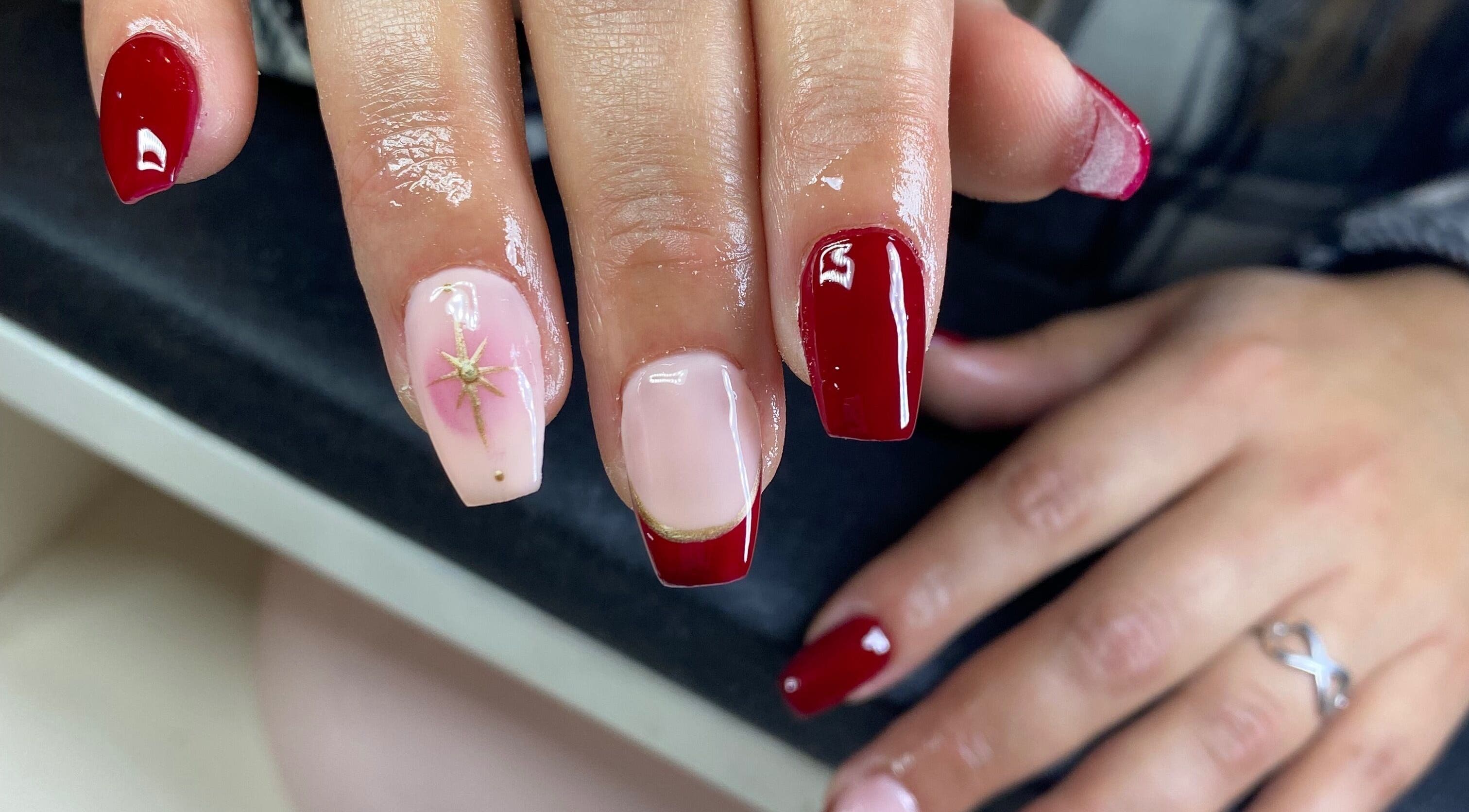Red and nude manicure with star design at Caminnails, Mar Del Plata, Provincia De Buenos Aires, AR.