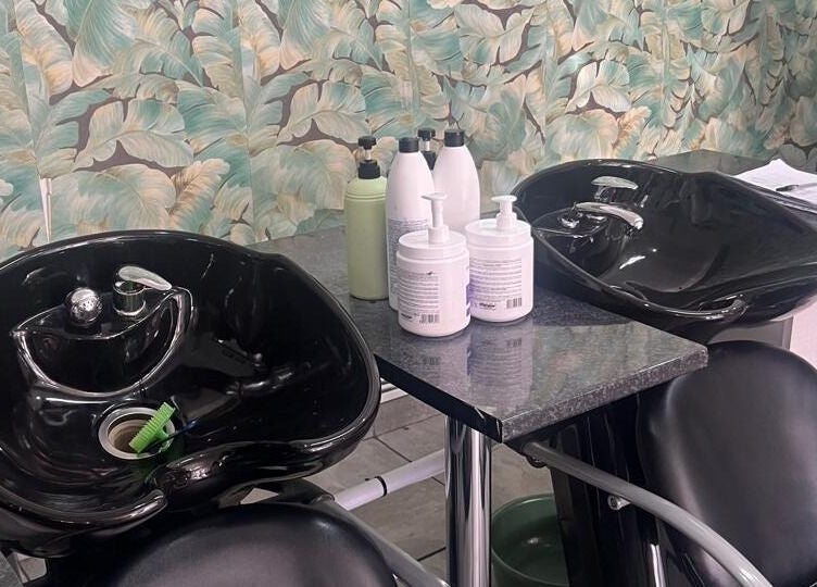 Stylish wash station at Sheckies Hair and Beauty Salon, Cape Town, Western Cape, ZA with tropical decor.