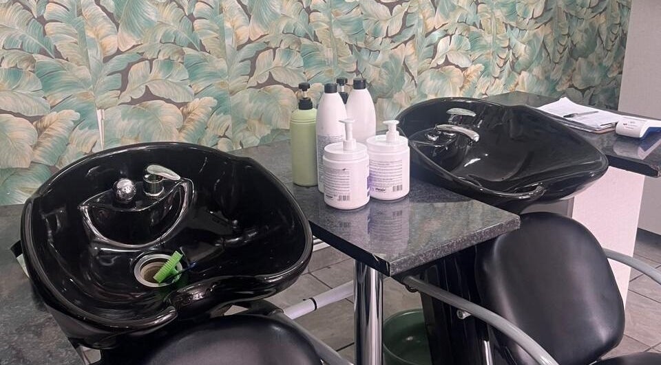 Stylish wash station at Sheckies Hair and Beauty Salon, Cape Town, Western Cape, ZA with tropical decor.