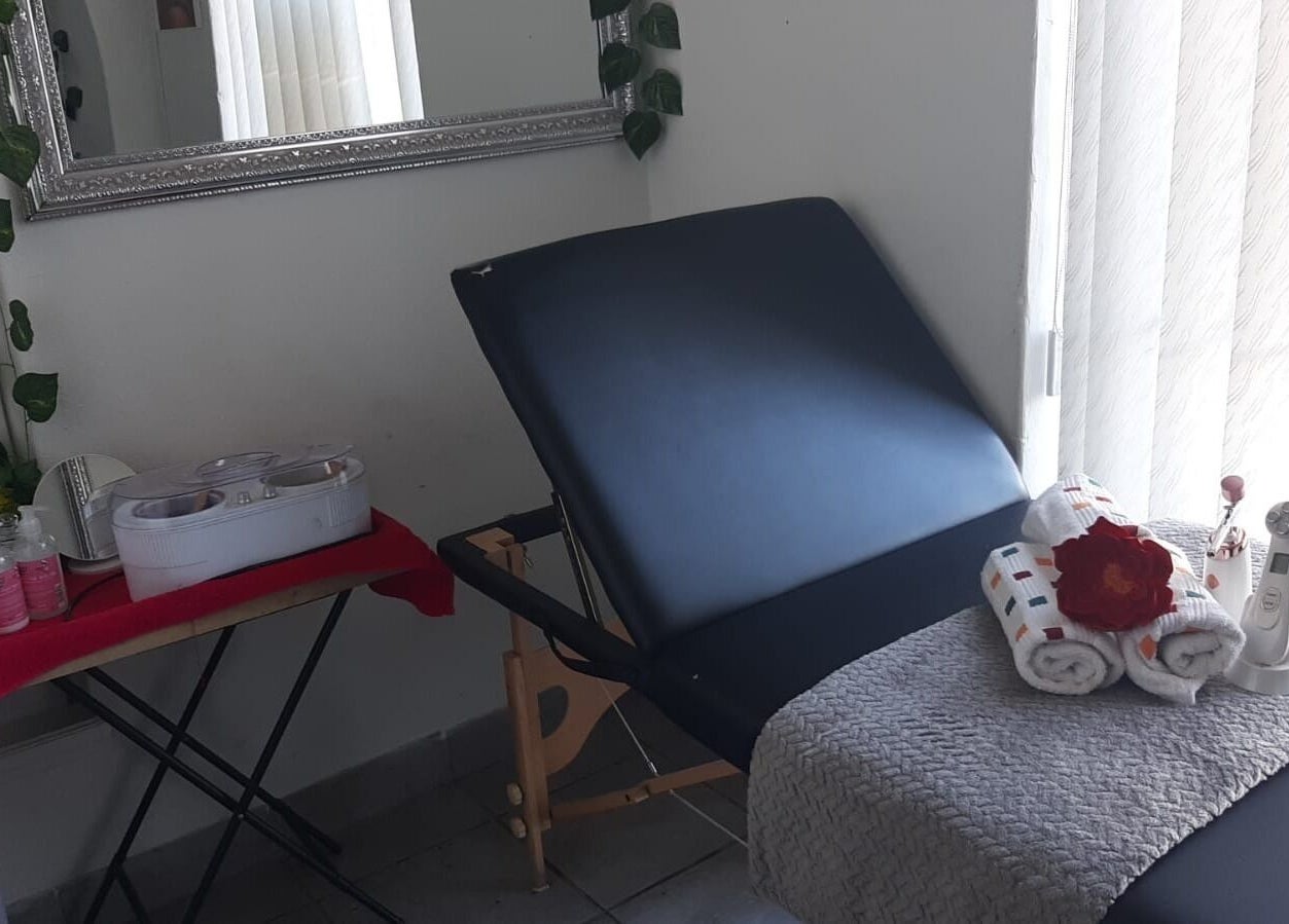Cozy treatment room at Sheckies Hair and Beauty Salon, Cape Town, Western Cape, ZA with a massage bed and decor.
