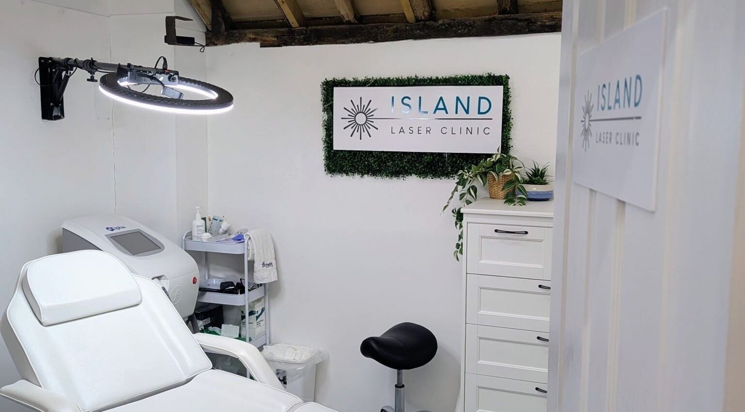 Relaxing treatment room at Island Laser Clinic, Hayling Island, England, GB, featuring a modern white chair.