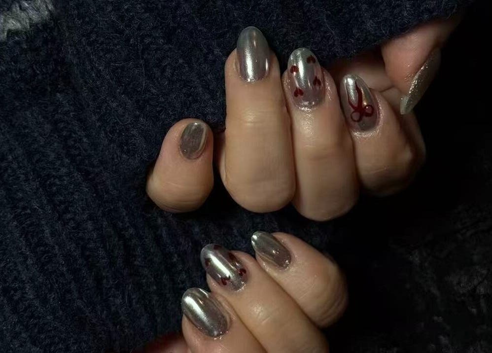 Shiny chrome nails with red heart designs at Last Quarter Nail, Melbourne, Victoria, AU.