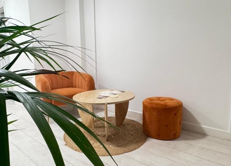 Modern waiting area at MP Nails and Beauty, Northampton, England, GB with orange seating and green plants.