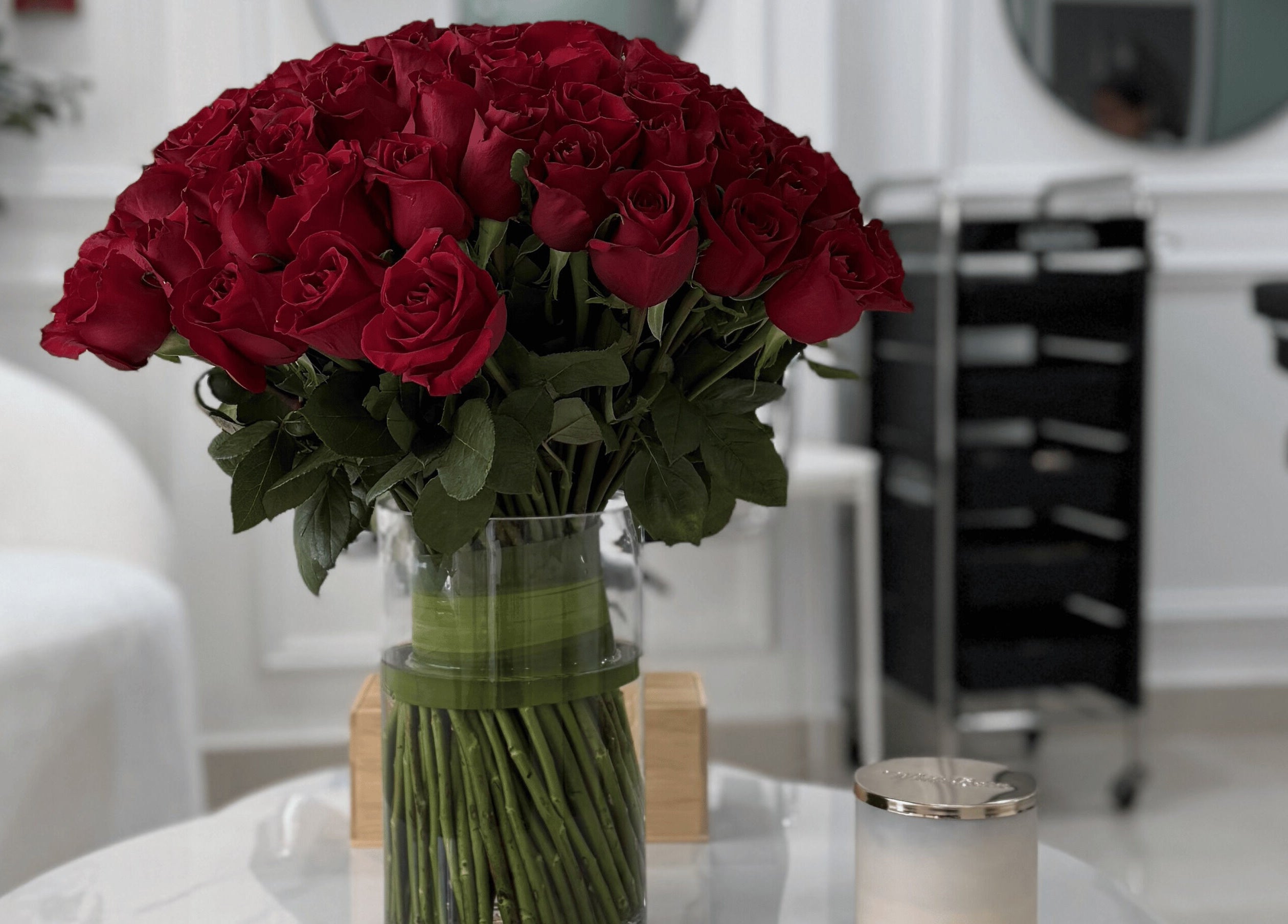 Elegant red roses in a vase at Maison Haniel, Dubai, AE, enhancing the sophisticated salon ambiance.