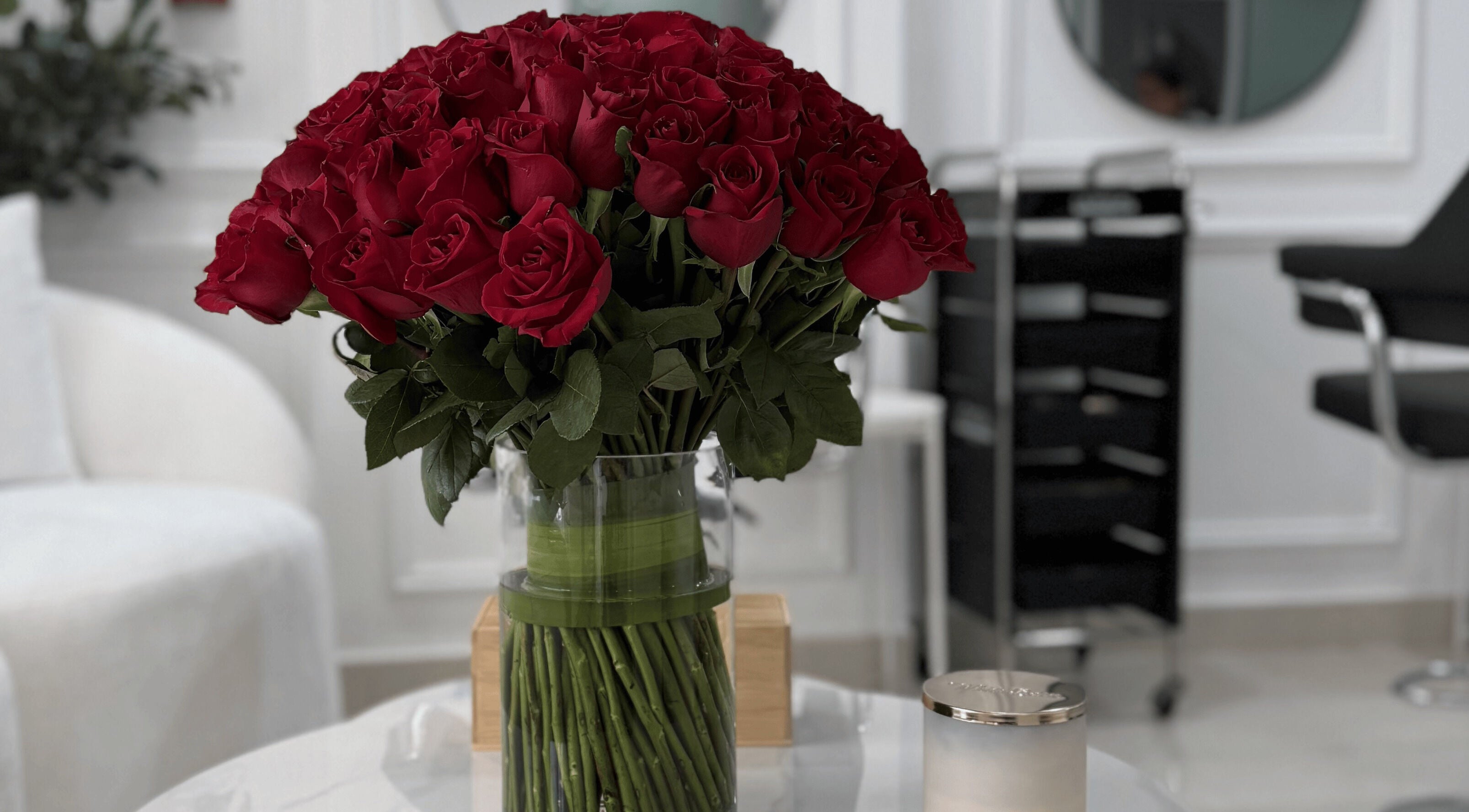 Elegant red roses in a vase at Maison Haniel, Dubai, AE, enhancing the sophisticated salon ambiance.