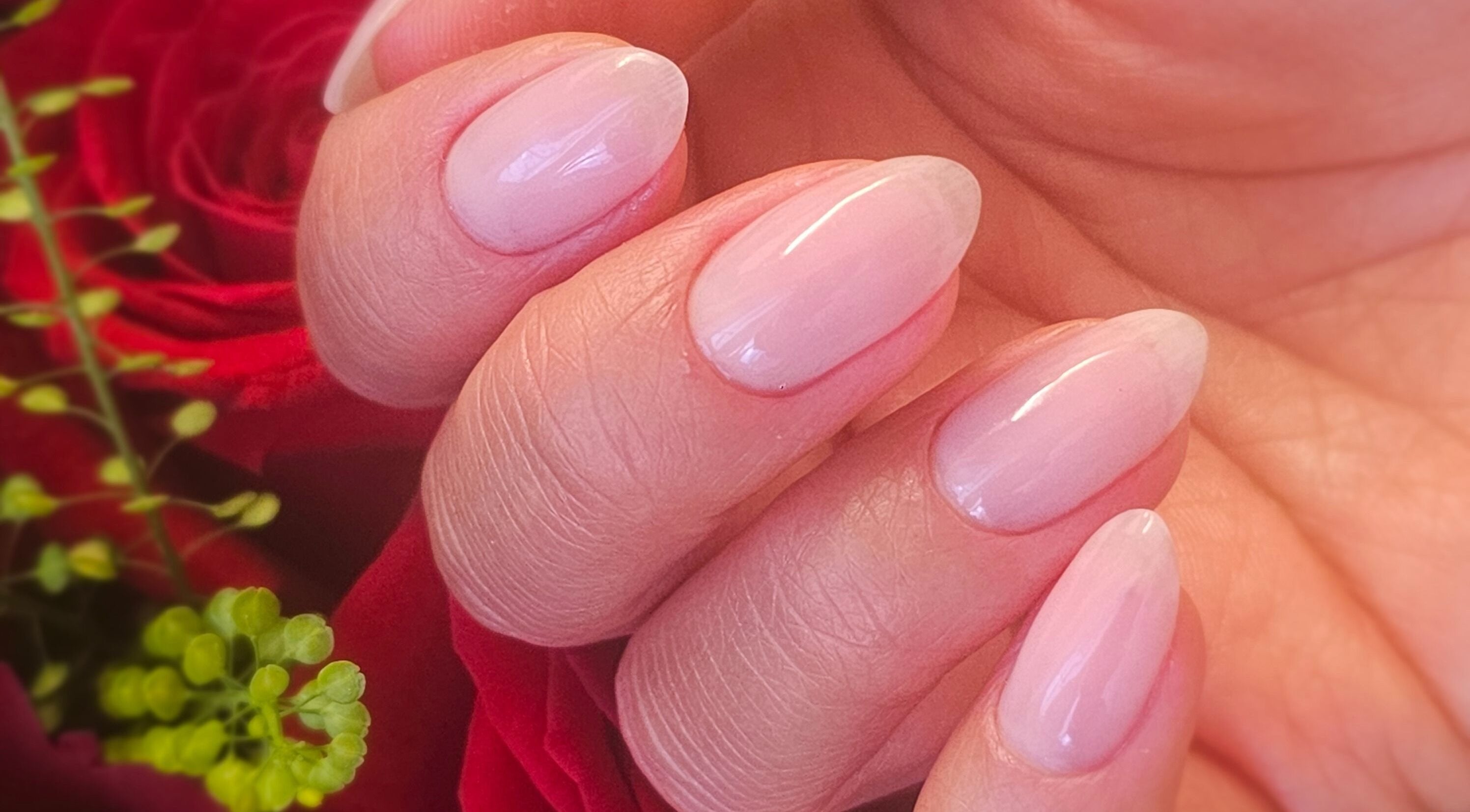 Beautifully manicured nails with a soft pink hue at Nails by Julie @ Hair & Co London, London, England, GB.