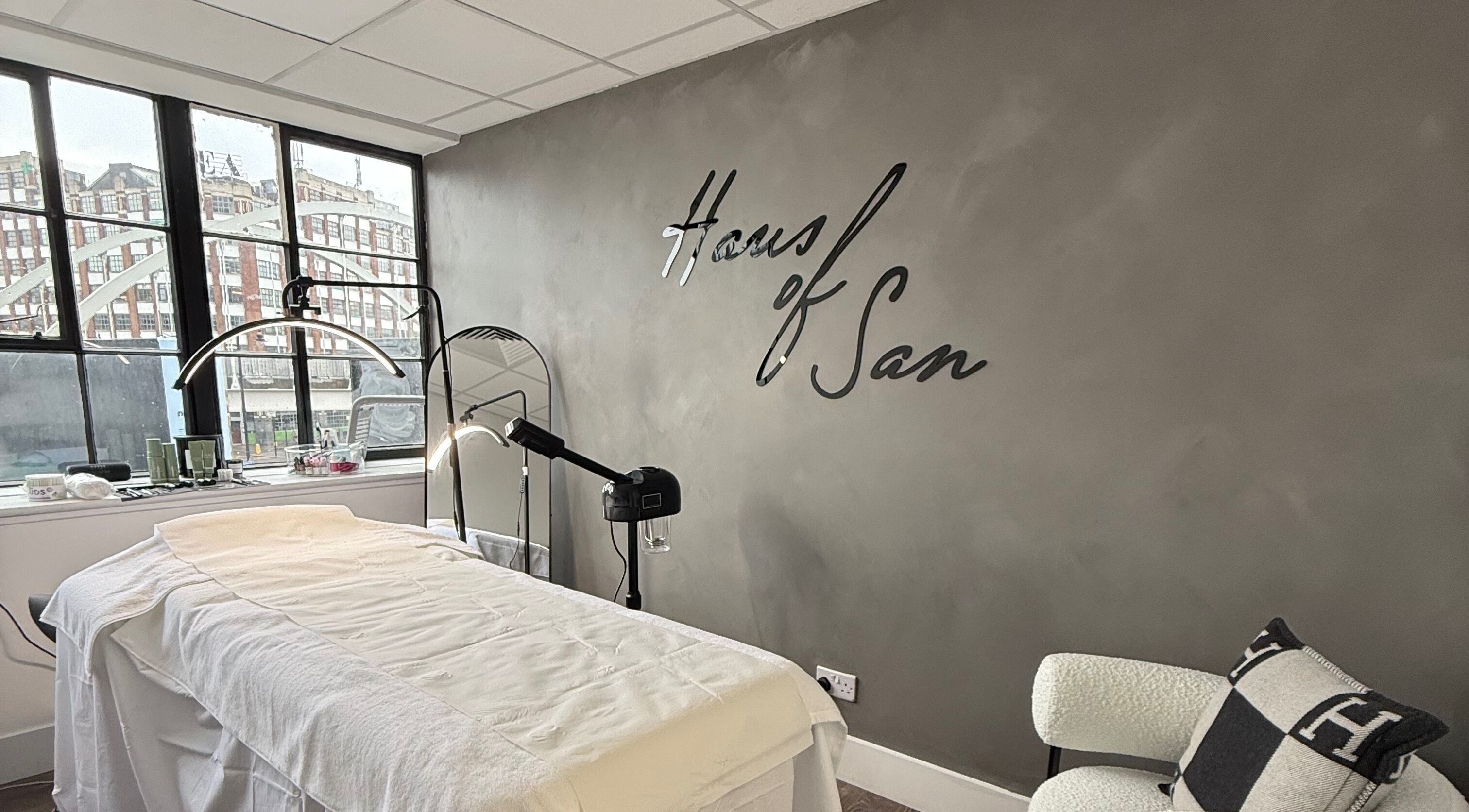 Treatment room at Haus of Sar, featuring a plush bed and modern decor in London, England, GB.
