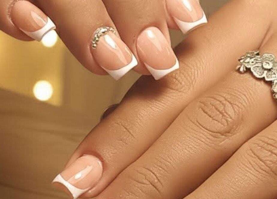 Elegant French manicure with gemstone at Nails by Yuli, Greenacres, Florida, US.