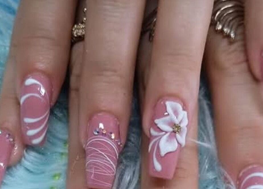 Exquisite floral nail design by Nails by Yuli, Greenacres, Florida, US. Delicate petals adorn chic pink nails.