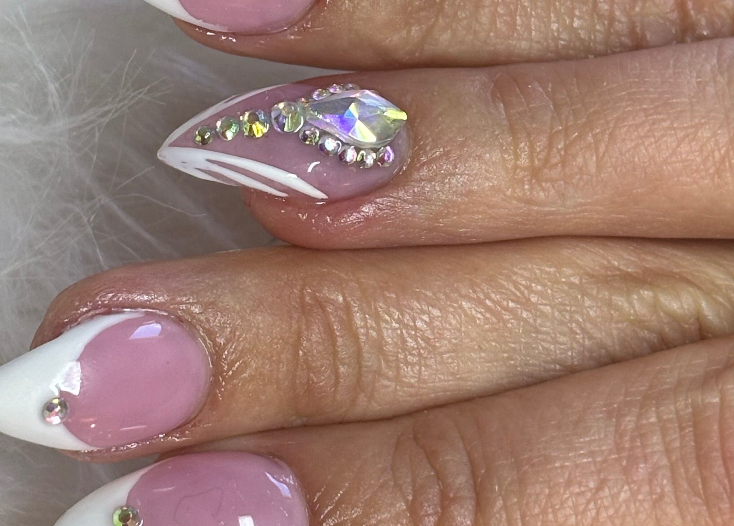 Stunning pink and white stiletto nails with rhinestones at Nails by Yuli, Greenacres, Florida, US.