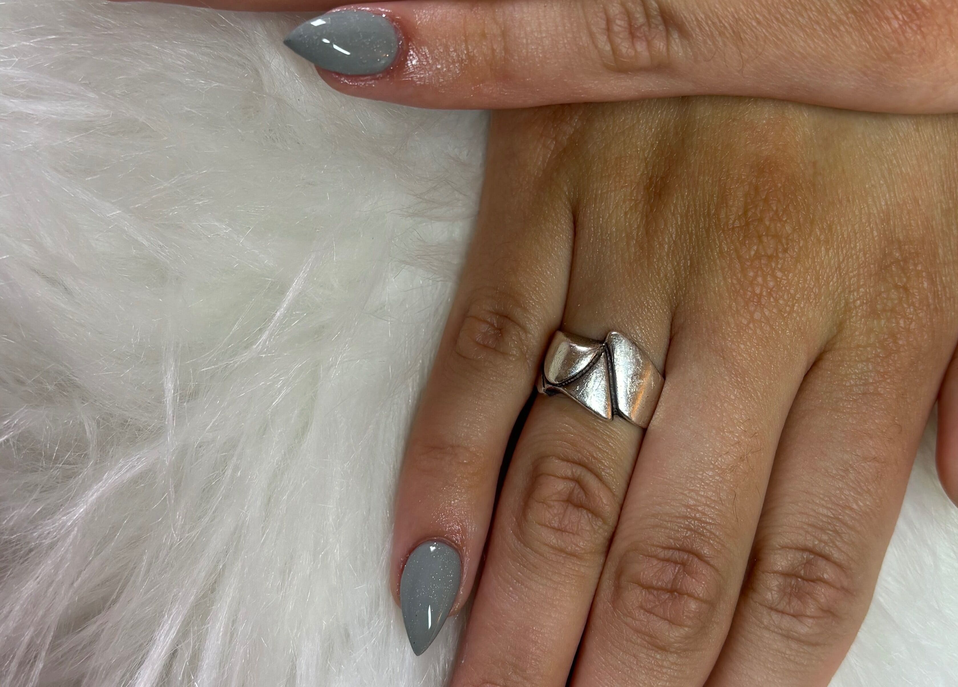 Gray polished nails with a silver ring at Nails by Yuli in Greenacres, Florida, US.