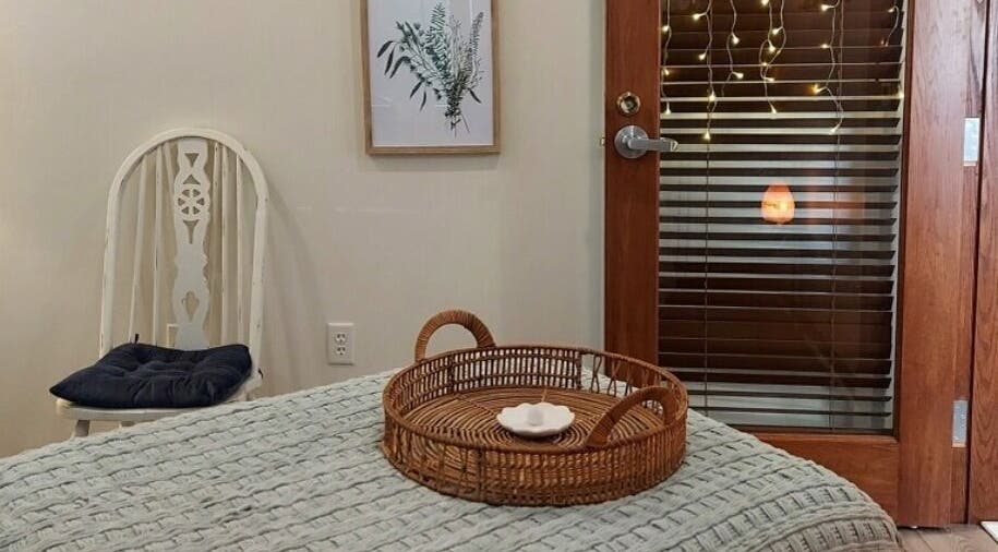 Cozy room at Heathers Healing Haven, Lakeville, MA, with wicker tray and soothing decor.