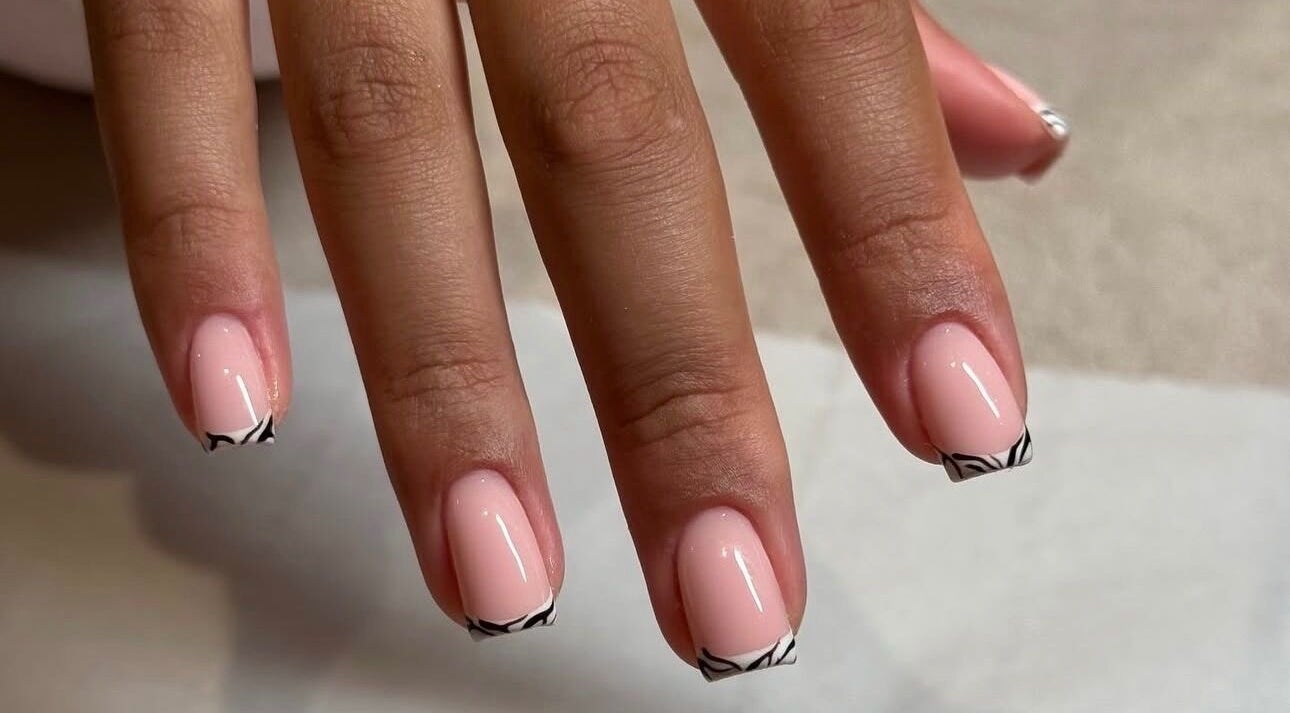 Close-up of elegant nail art at Biab By Amber in Watford, England, GB, featuring minimalist black tips.