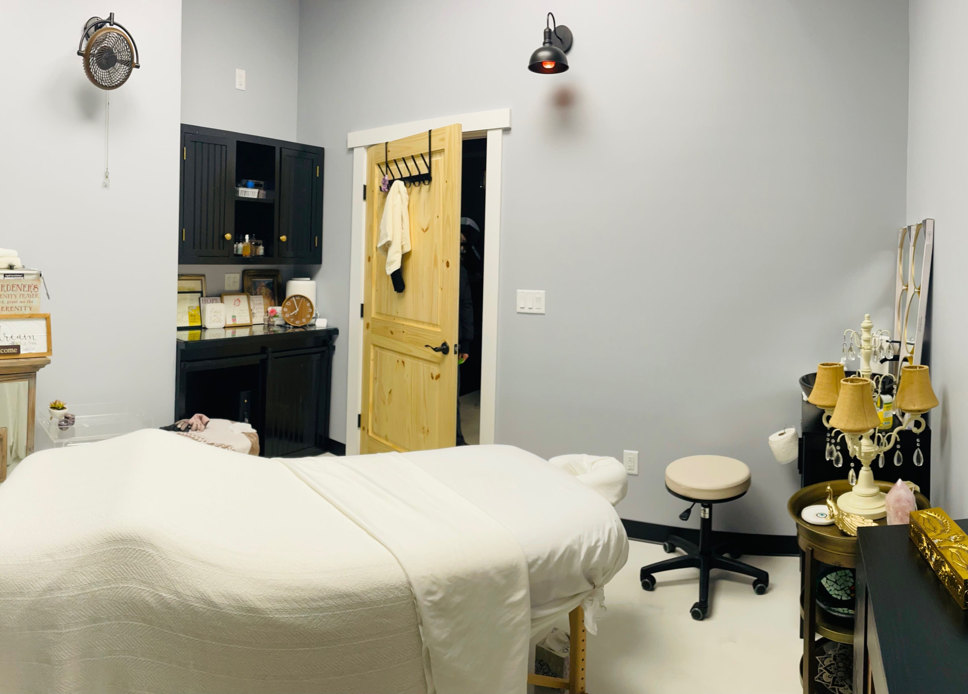 A tranquil treatment room at AUM Body Bliss LLC, Saint Albans City, Vermont, US, featuring a cozy massage table.