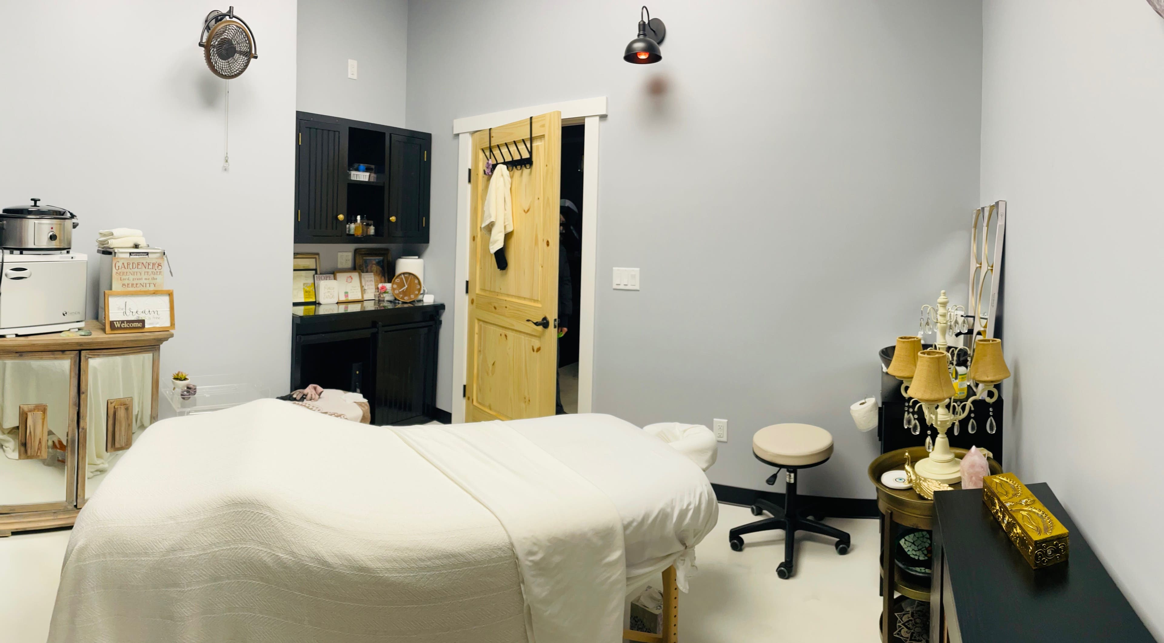 A tranquil treatment room at AUM Body Bliss LLC, Saint Albans City, Vermont, US, featuring a cozy massage table.