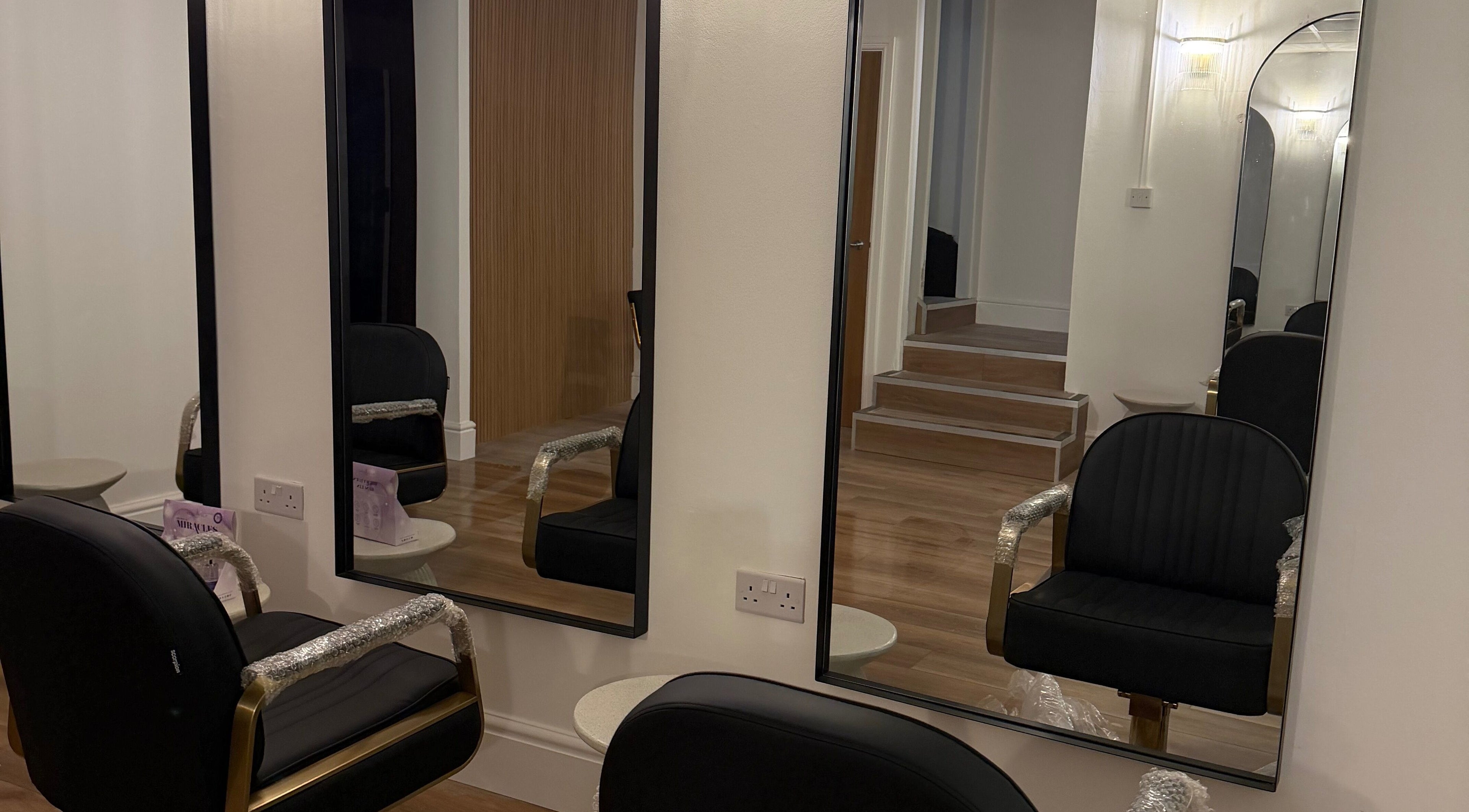 Chic salon interior featuring elegant black chairs at Gabriella Bellusci Hair, Darwen, England, GB.