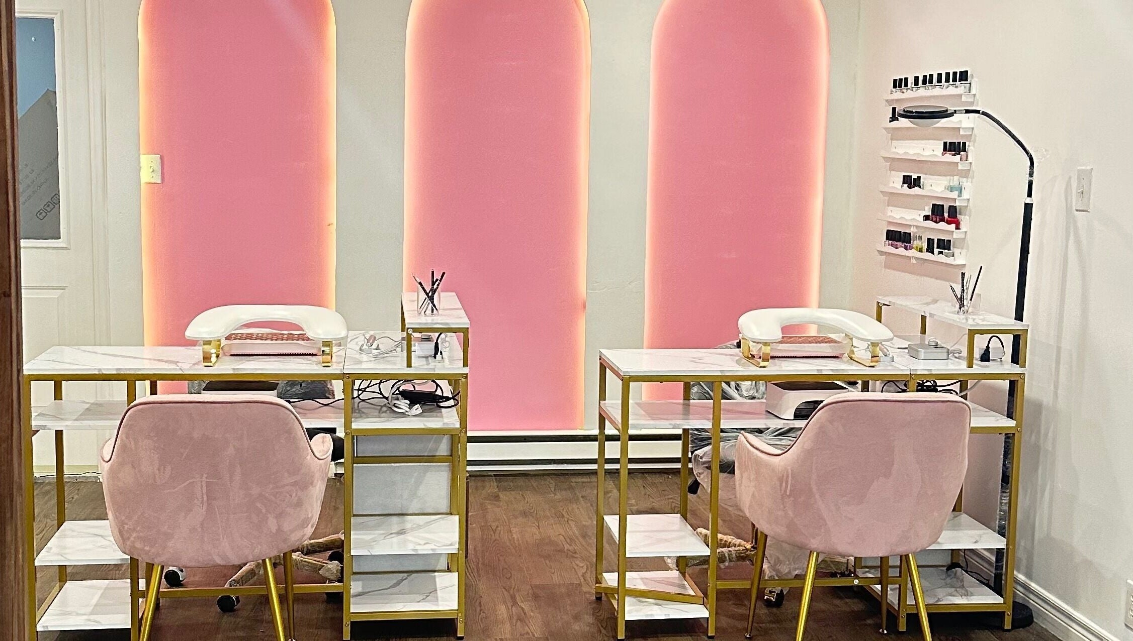 Modern nail salon at Mimi Medical Spa, Dieppe, New Brunswick, CA with pink chairs and elegant decor.
