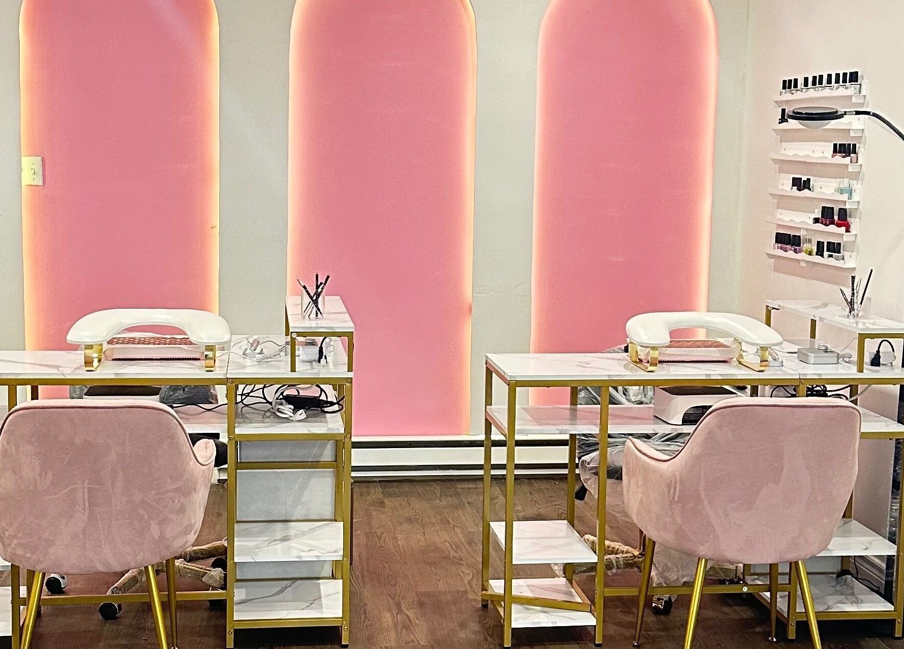 Modern nail salon at Mimi Medical Spa, Dieppe, New Brunswick, CA with pink chairs and elegant decor.