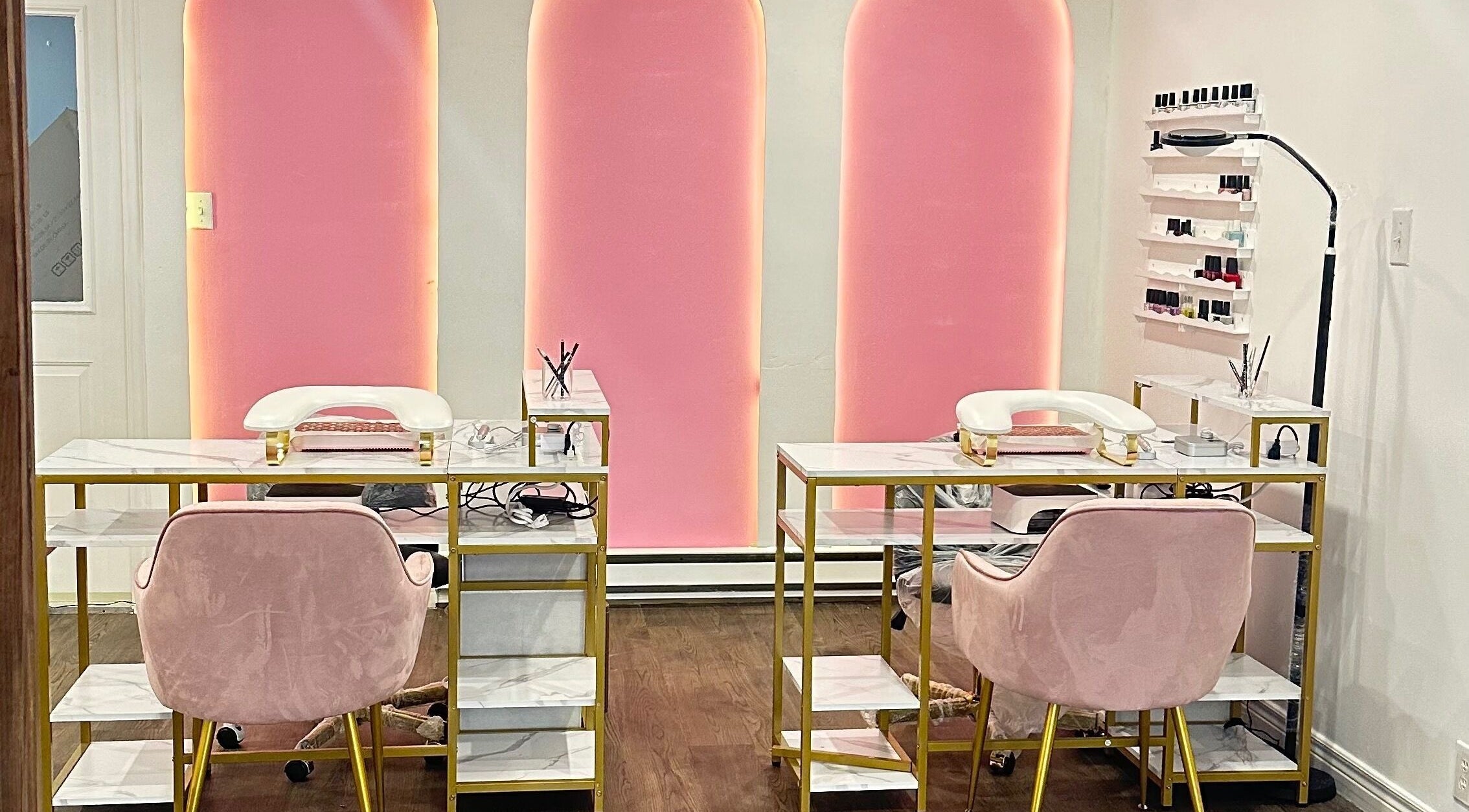Modern nail salon at Mimi Medical Spa, Dieppe, New Brunswick, CA with pink chairs and elegant decor.