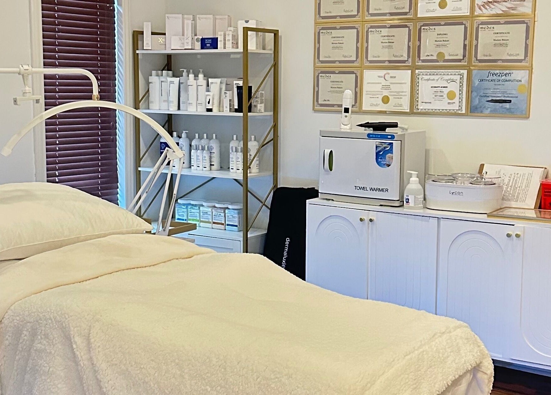 Relaxing treatment room at Mimi Medical Spa in Dieppe, New Brunswick, CA, showcasing cozy bed and skincare products.