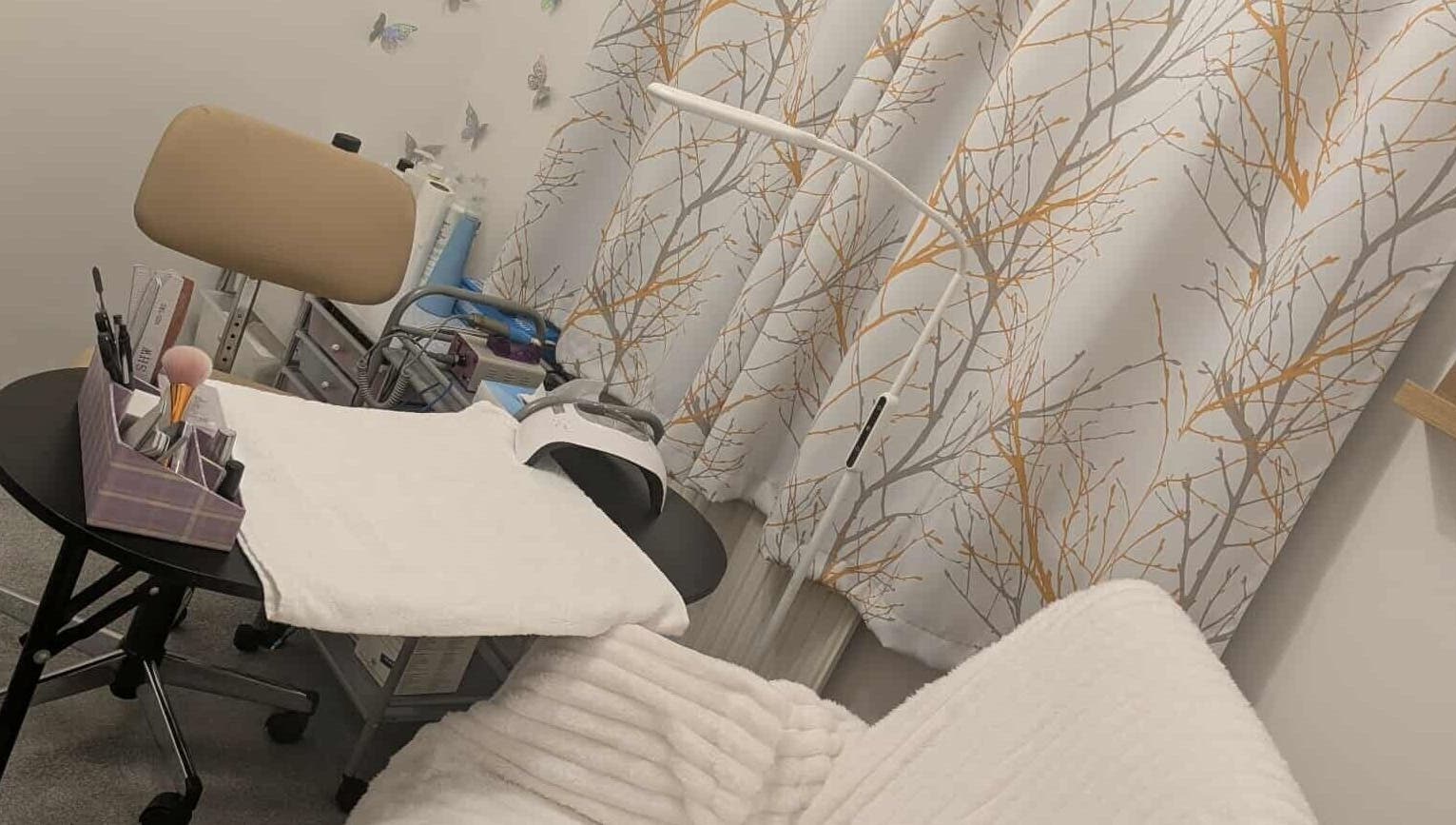 Agi Nails studio in Bulwark, Wales, GB with stylish decor and manicure tools on a table.