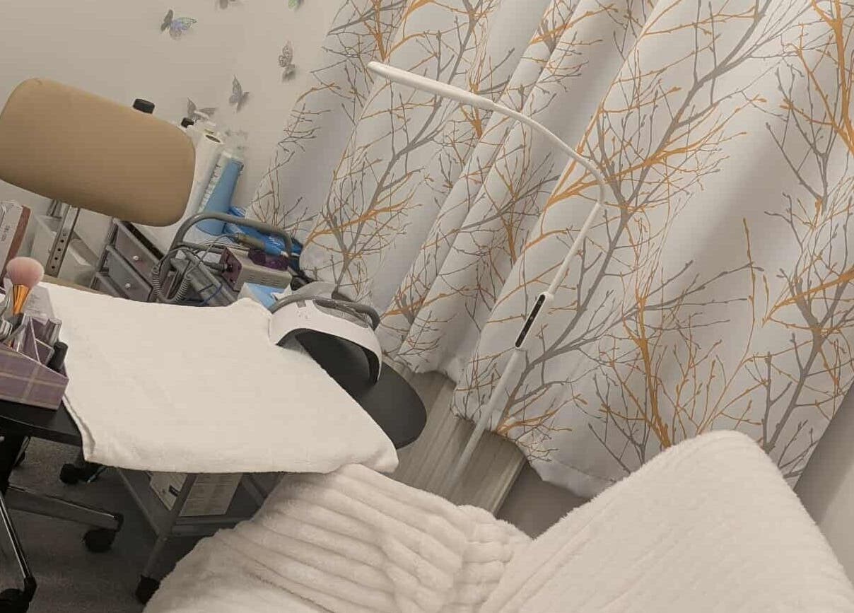 Agi Nails studio in Bulwark, Wales, GB with stylish decor and manicure tools on a table.