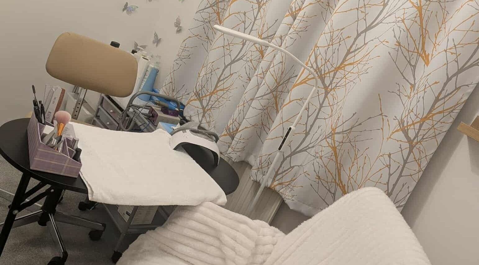 Agi Nails studio in Bulwark, Wales, GB with stylish decor and manicure tools on a table.