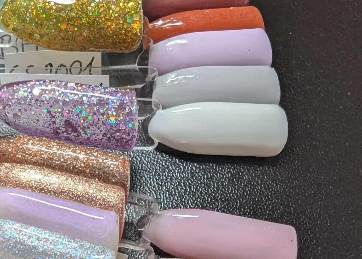 Vibrant glitter nail polish swatches at Agi Nails, Bulwark, Wales, GB showcase trendy manicure options.
