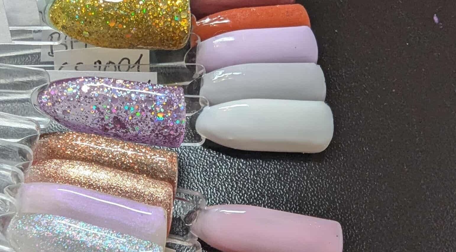 Vibrant glitter nail polish swatches at Agi Nails, Bulwark, Wales, GB showcase trendy manicure options.