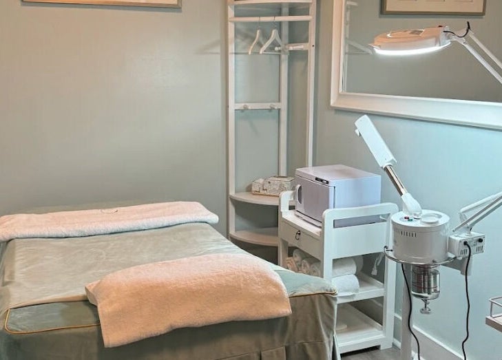 Peaceful therapy room at Relax Day Spa, New York, New York, US, featuring a cozy massage bed and soft lighting.