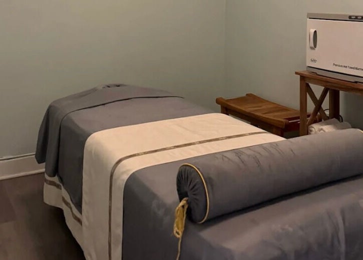 Cozy massage room at Relax Day Spa, New York, New York, US, featuring a soft bed in a serene setting.