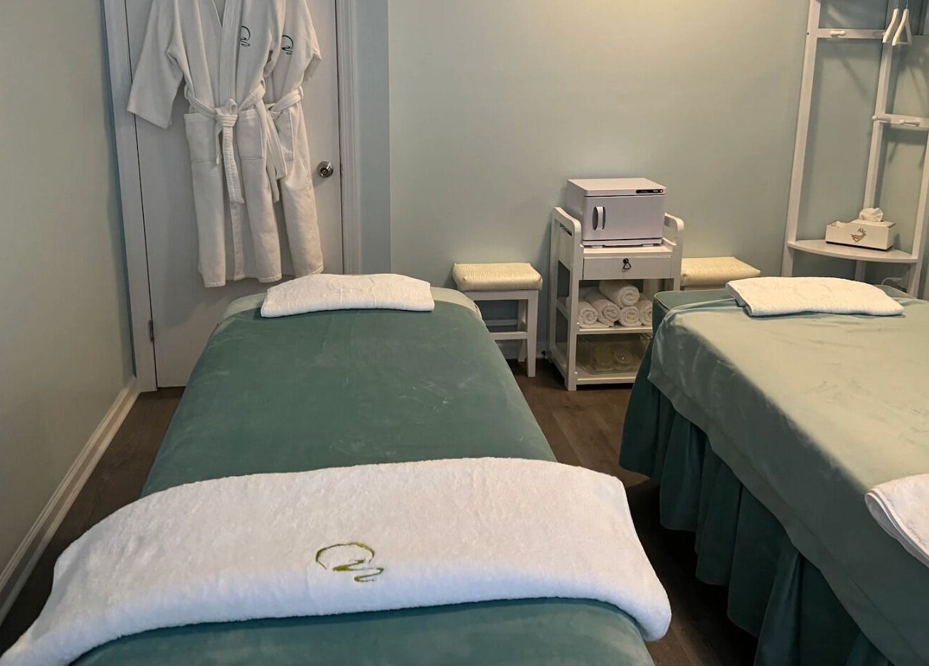 Relax Day Spa massage room with two tables in New York, New York, US, offering a tranquil ambiance.