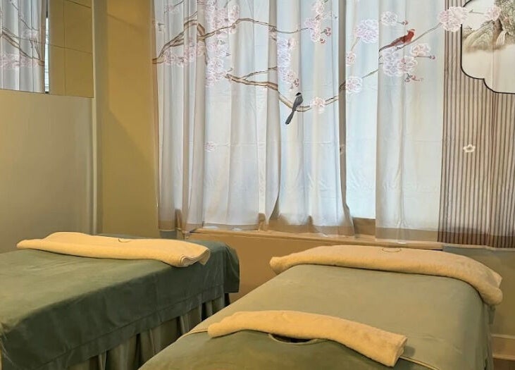 Relax Day Spa massage room with twin beds, New York, New York, US. Serene ambiance and soft lighting.