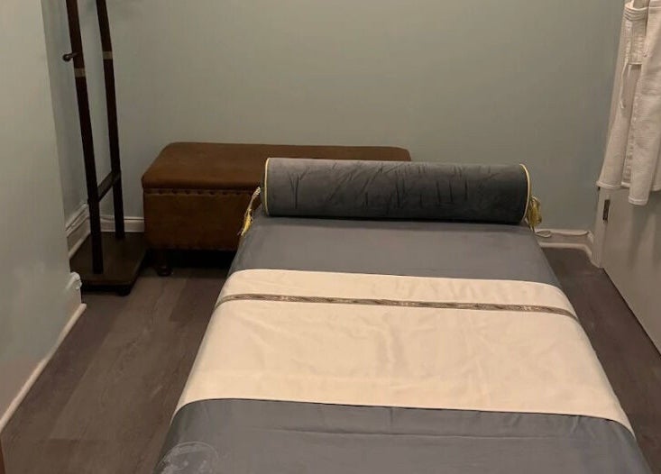 Tranquil massage room at Relax Day Spa in New York, New York, US, featuring a comfortable massage bed.
