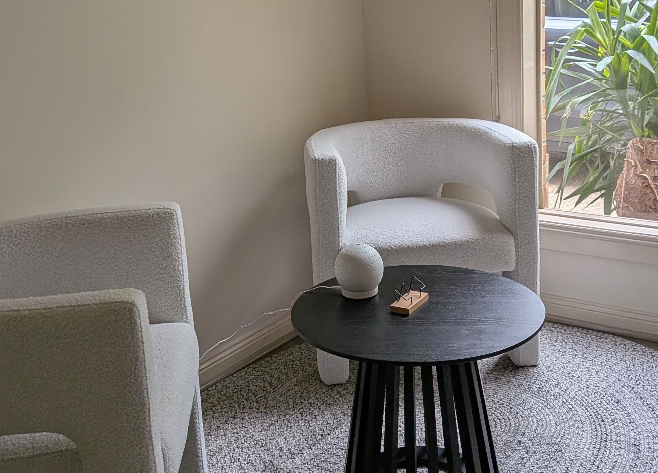 Cozy seating area at Lume Skin Aesthetics in Diamond Creek, Victoria, AU, with plush chairs and natural light.
